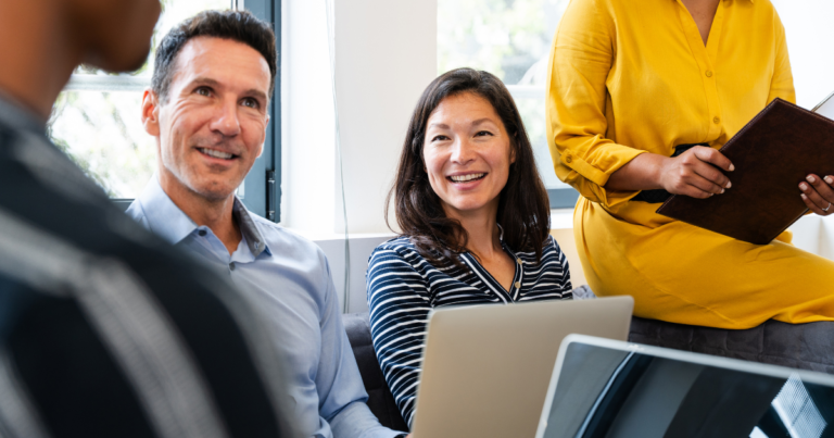 Business people at a meeting with 2 laptops